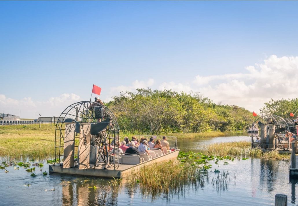 group of international tourists leaving from the airboat pier to explore the Florida Everglades