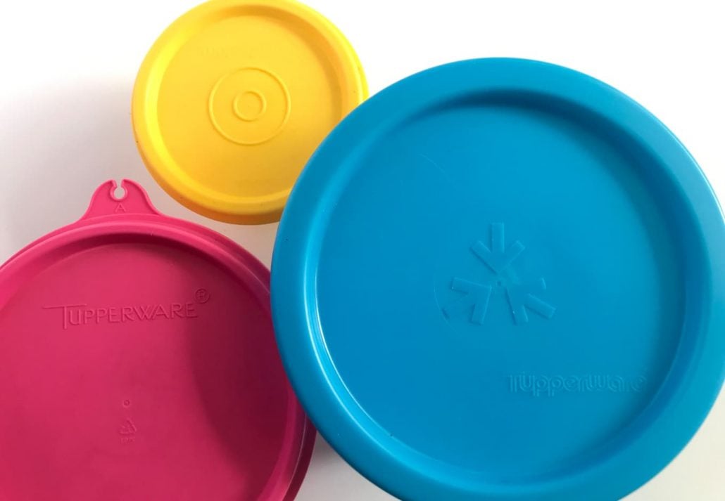Top view of Tupperware brand lid containers isolated on white background