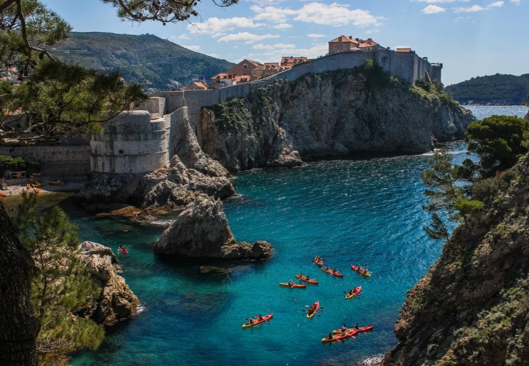 View of Dubrovnik West Harbor and the ancient city wall with sea kayaks in the foreground. 