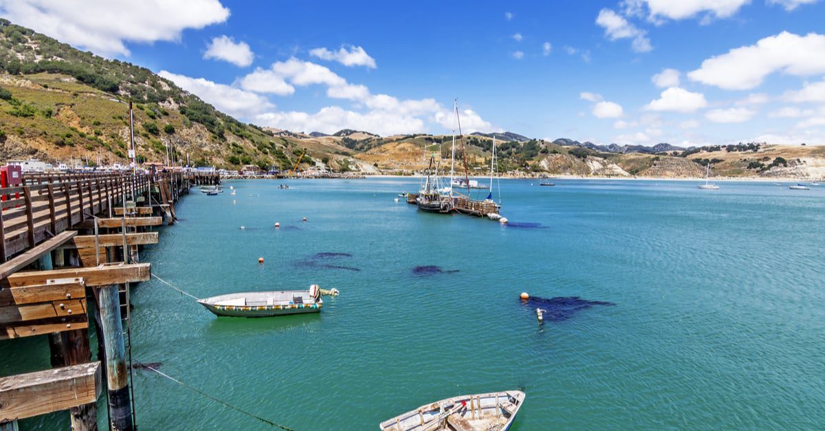 View of the blue ocean dotted with boats in San Luis Obispo, California.
