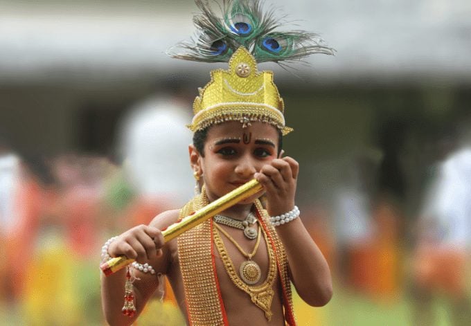 A young boy dressed as Lord Sri Krishna on the Janmashtami festival (Ashtamirohini) day for the procession