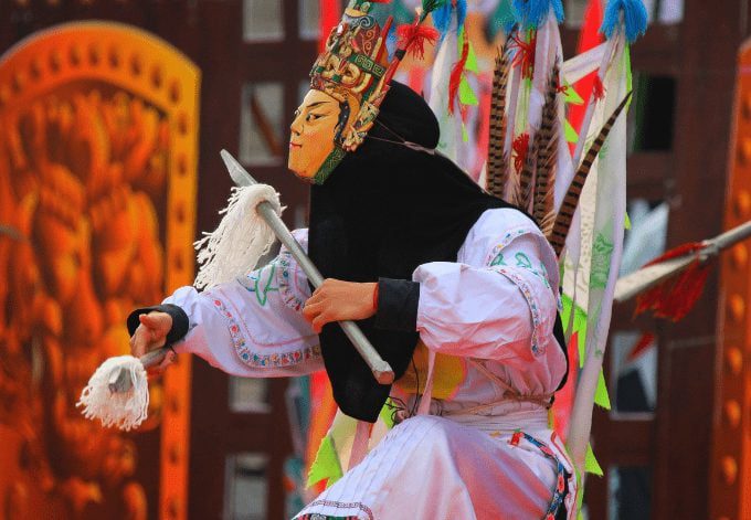 Traditional Yi Nationality drama performs in public in Yi Nationality torch festival, in Xing Yi town, Gui Zhou province of China.