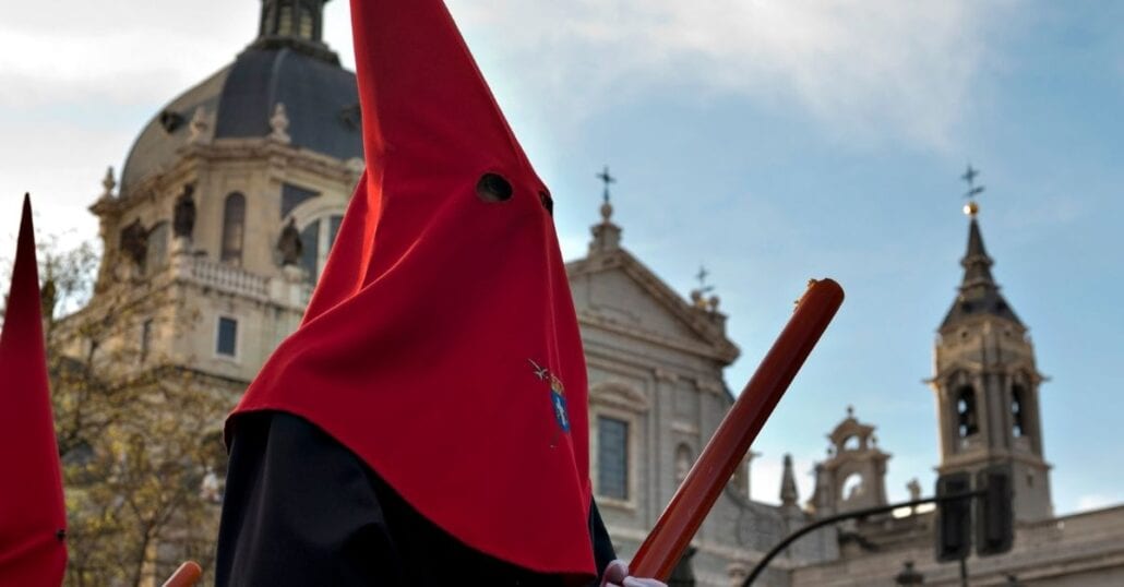 Man wearing a traditional religious costume during an Easter procession in Spain.