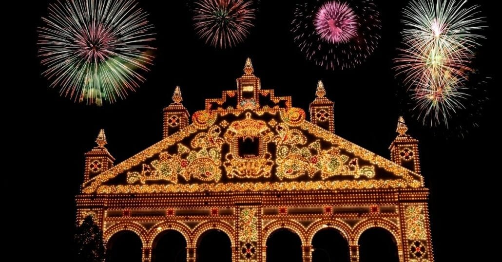Colorful fireworks at night during the Seville Fair.