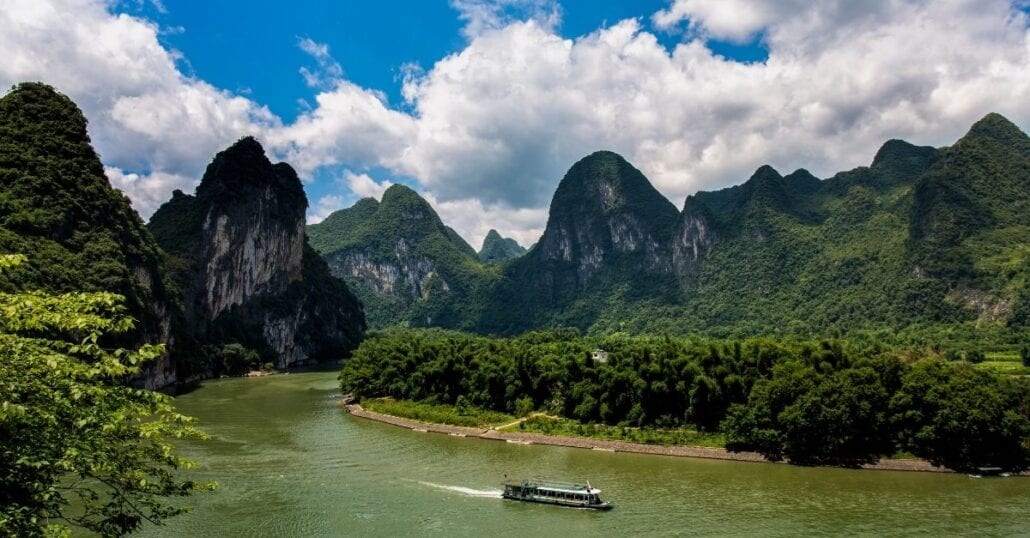 View of the Li River bypassed by the green mountains of the Guilin and Lijiang River National Park, in China.