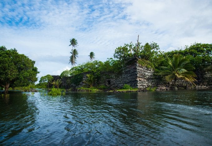The Nan Madol waterways lined with megalithic constructions and forests.