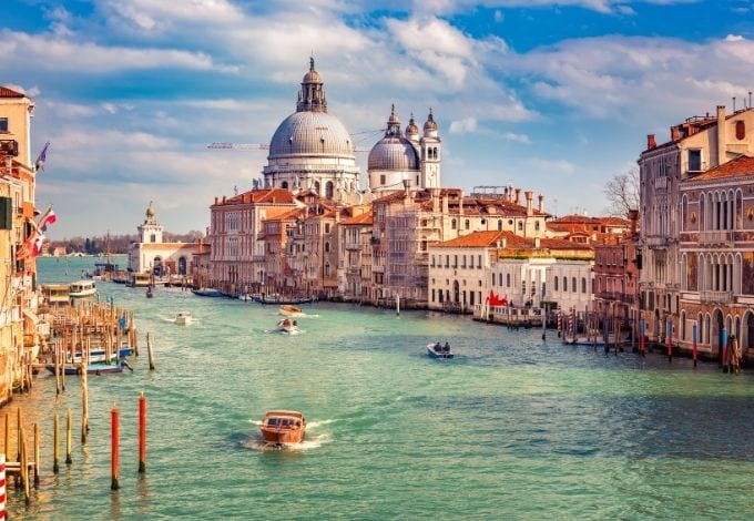 The Grand Canal, in Venice, lined by historic terracota buldings.