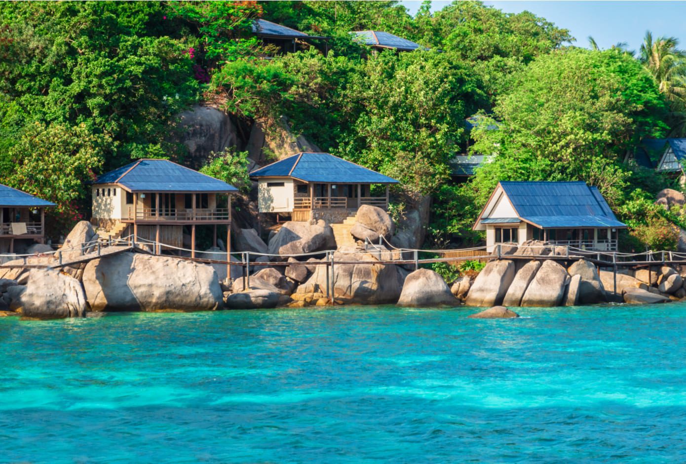 Bungalow over water with tropical vegetation in background in Ko Tay, Chumphon Gulf of Thailand.