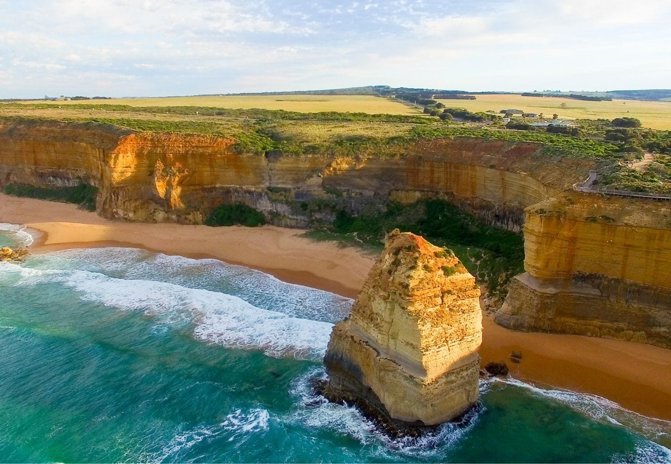 The turquoise ocean surrounded by cliffs on the Great Ocean Road, in Australia.