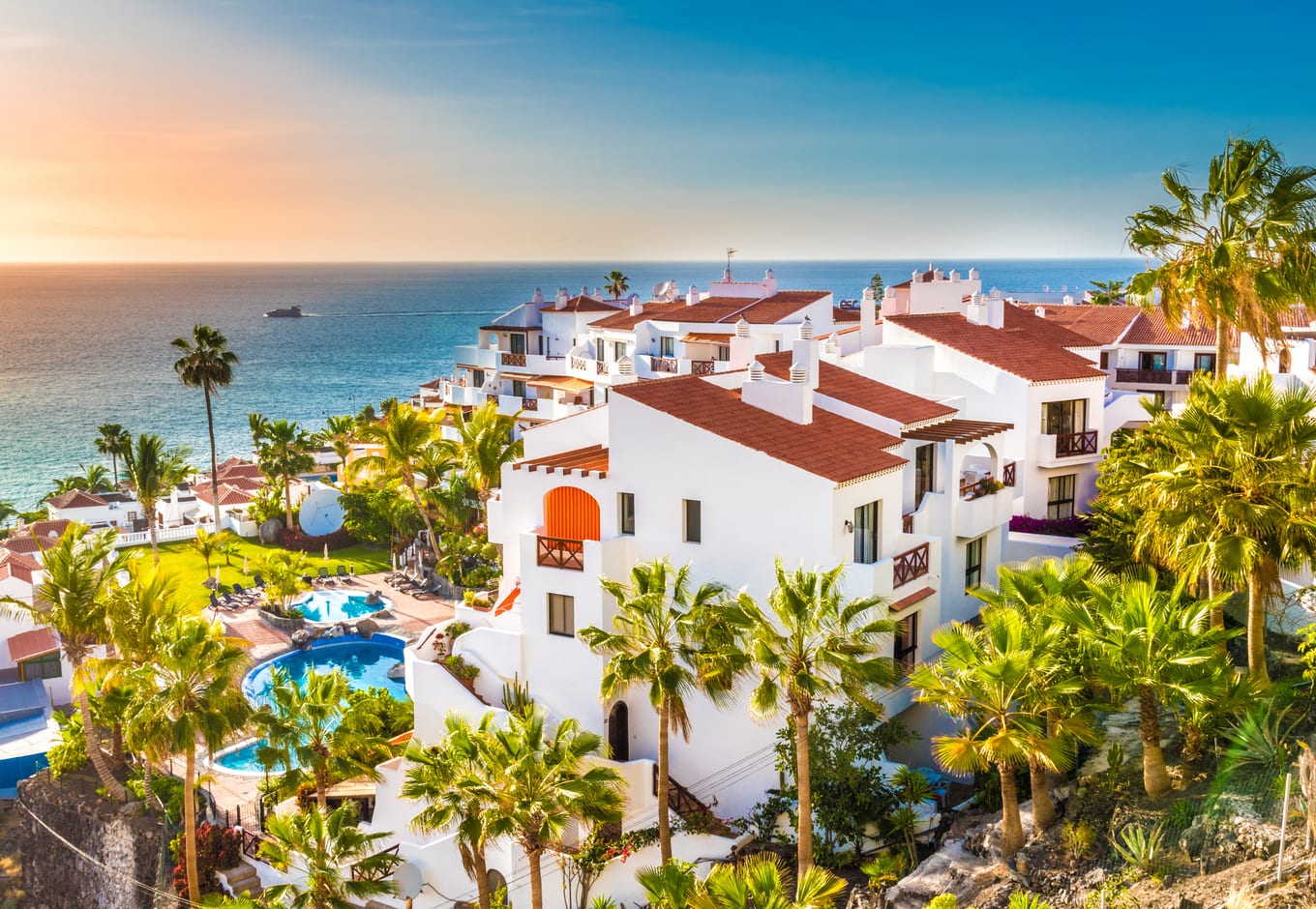 View of a seaside hotel surrounded by palm trees in Tenerife, Canary Islands, Spain.