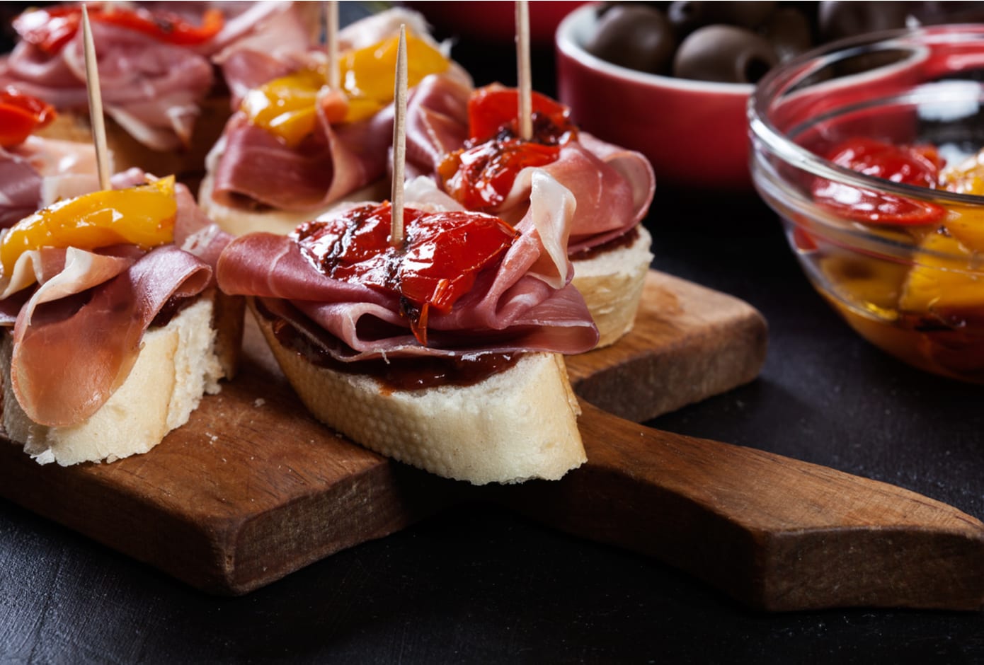Spanish tapas with slices jamon serrano and grilled pepper.