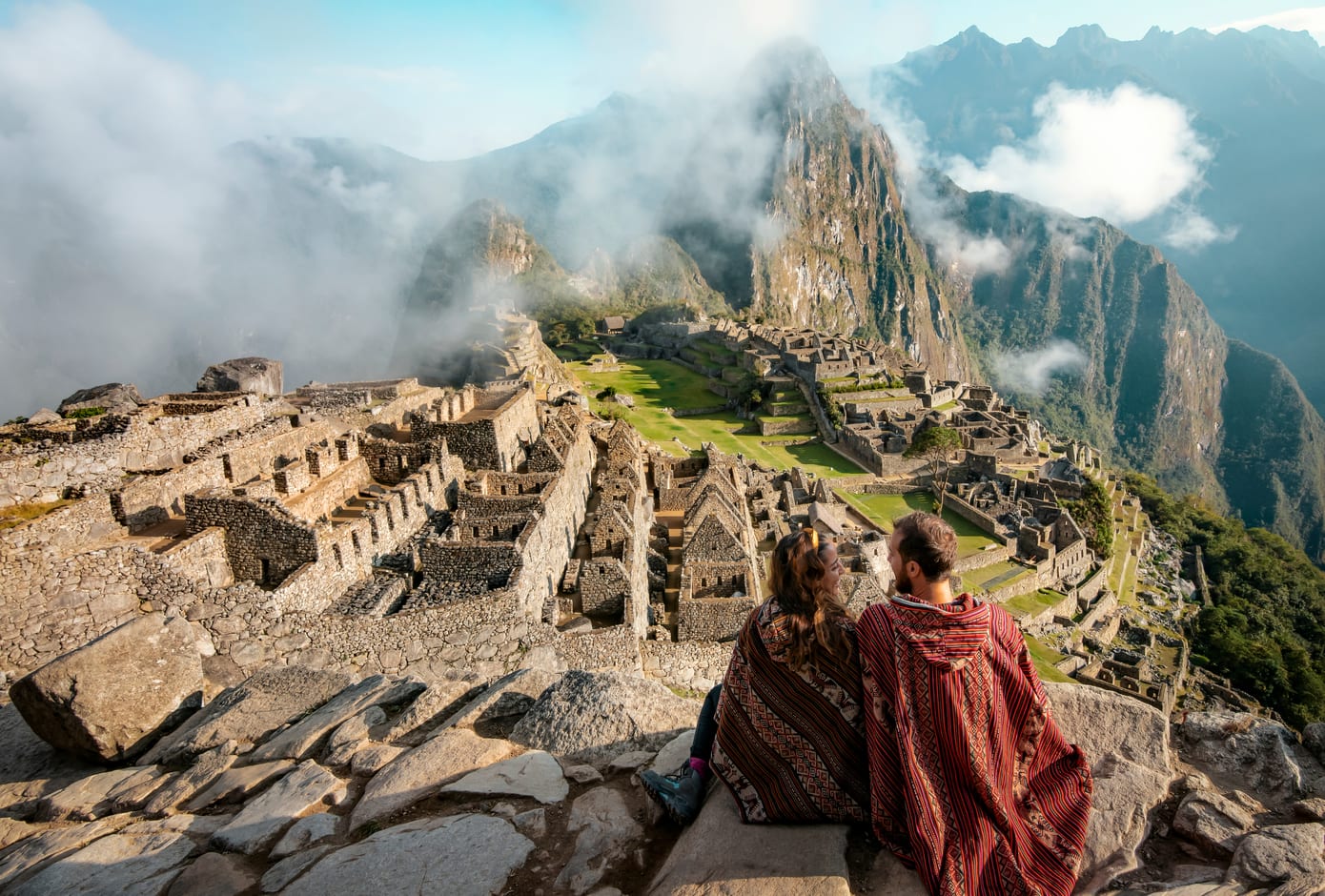 Couple dressed in ponchos in Machu Picchu, Peru.