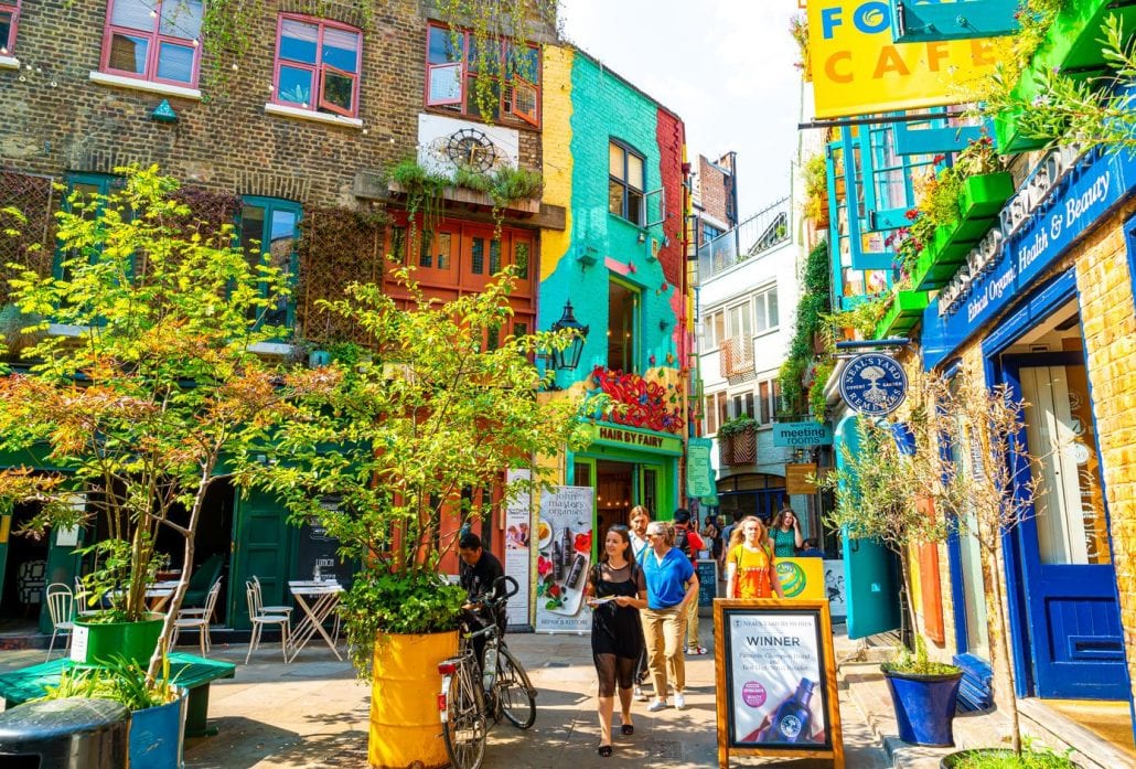 A view of colourful buildings in Neals Yard during the day. Neals Yard hidden passage near Covent Garden in London, United Kingdom.