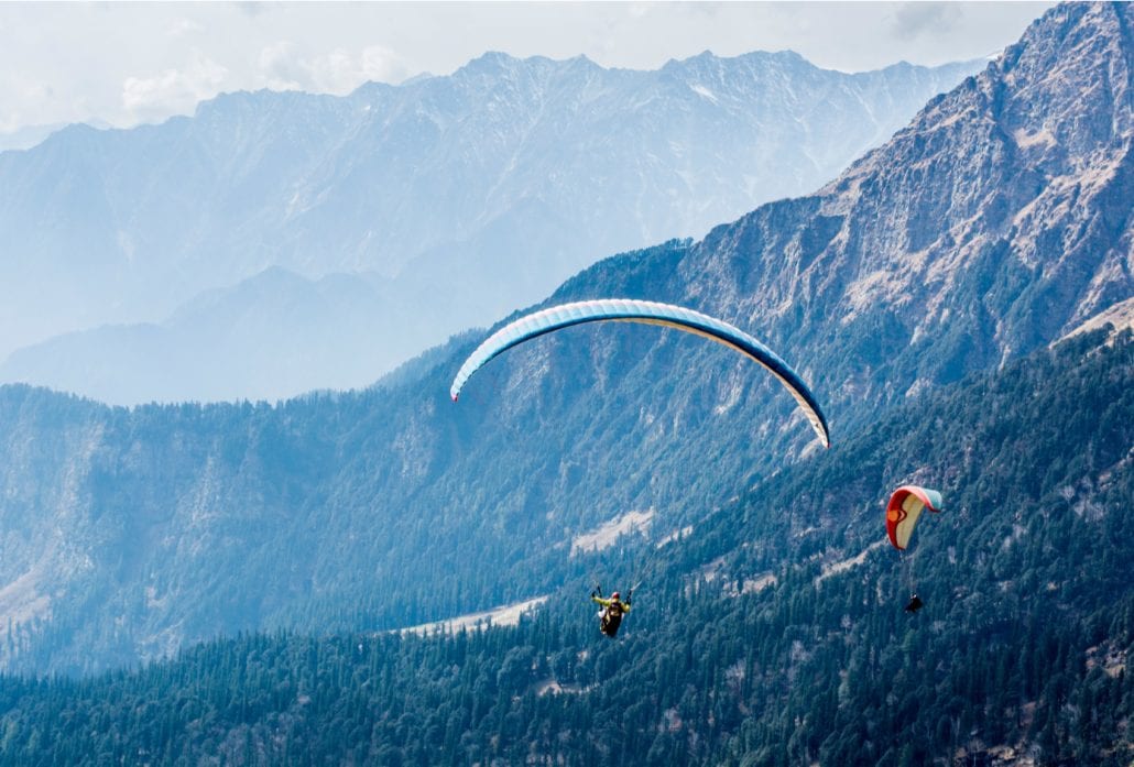 Two people paragliding in Solang Valley, in India.