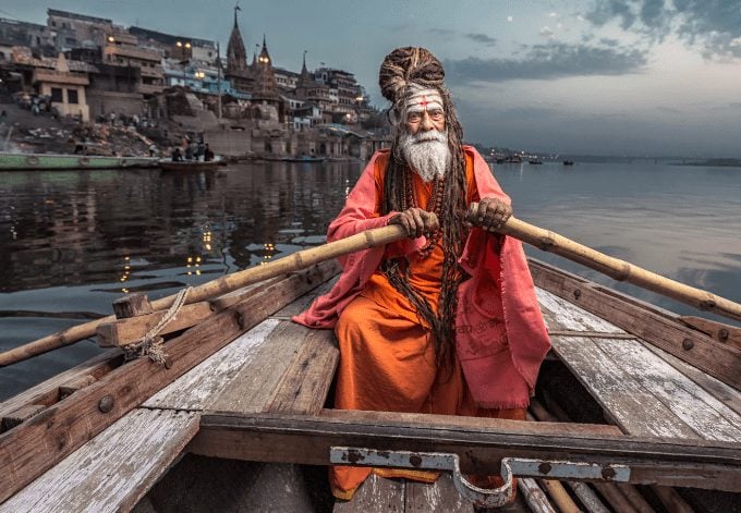 Portrait of sadhu Baba Nondo Somendrah, in a boat on the Ganges River in Varanasi, India.