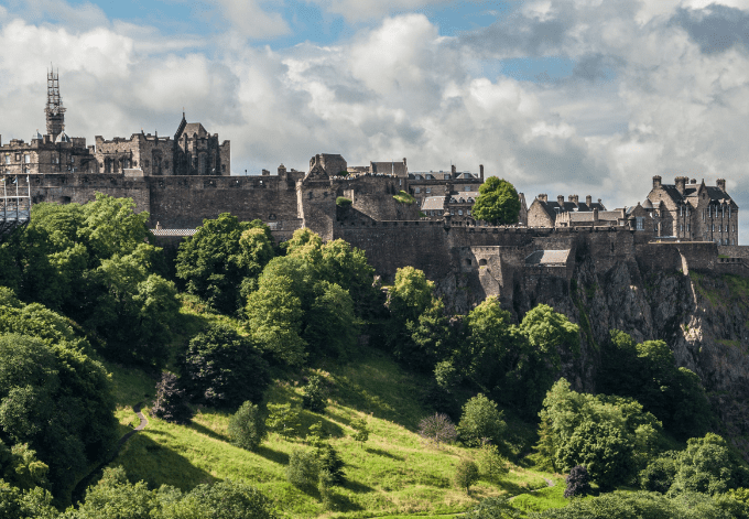 The Edinburgh Castle perched atop the Castle Rock, in Edinburgh, Scotland.