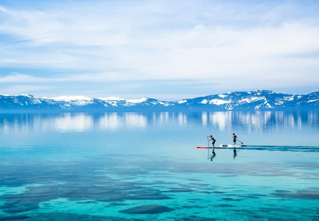 Two men paddleboarding on Lake Tahoe.