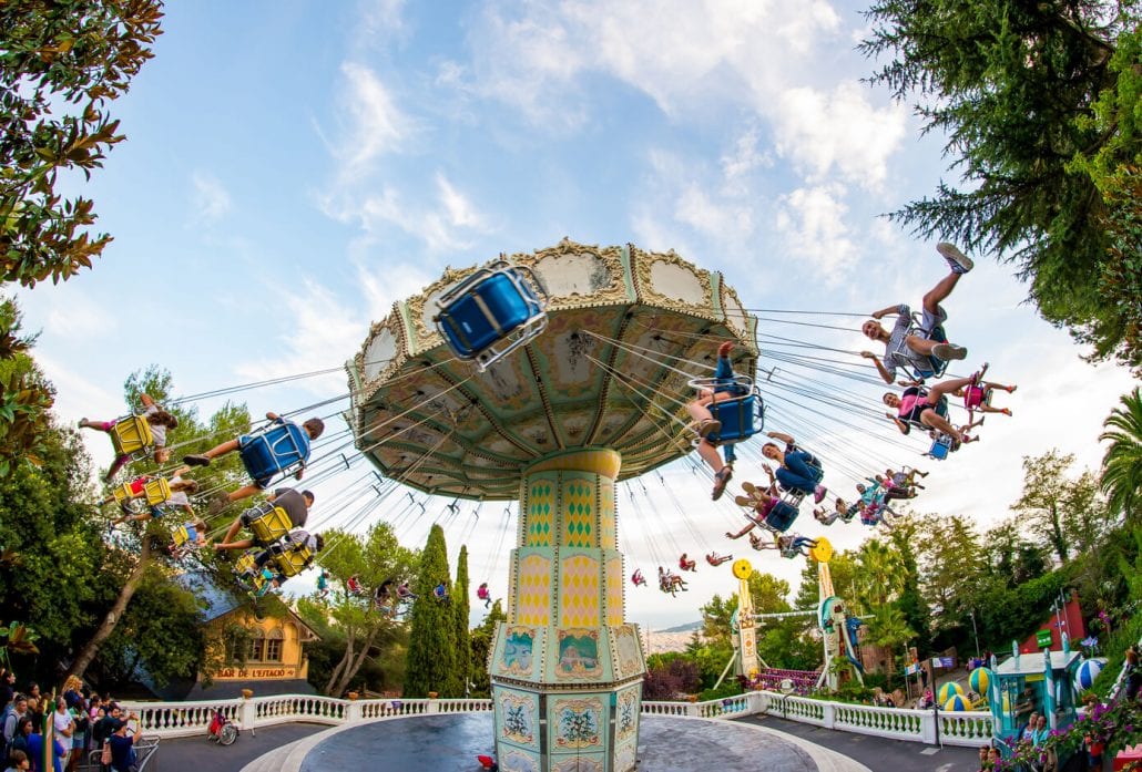 Kids swinging on a ride at the Tibidabo Amusement Park at Barcelona, Spain.