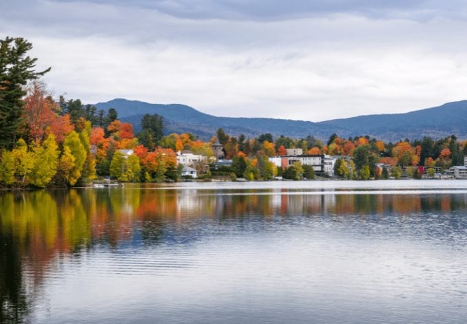 Buildings Among Colourful Trees on the The Shores of Mirror Lake in Lake Placid, NY, on a Cloudy Autumn Day