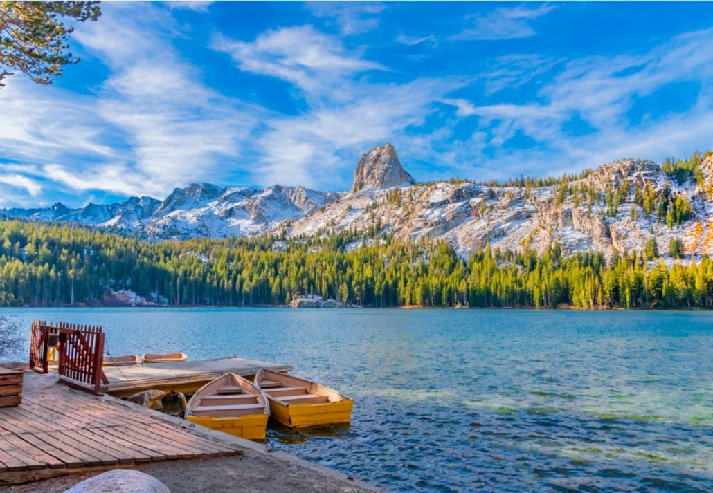 Boats sit at the dock at Lake George under the watchful eye of the Crystal Crag peak. This peak is in Mammoth Lakes in Central California, in Sierra Nevada Mountains.