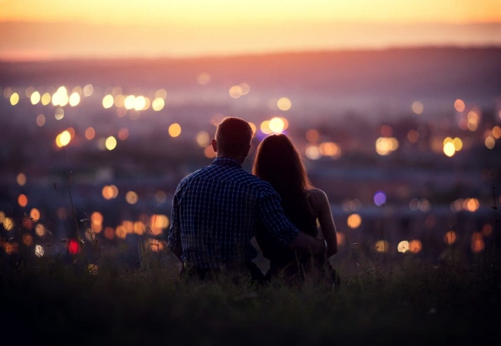 Couple watching a romantic sunset together.