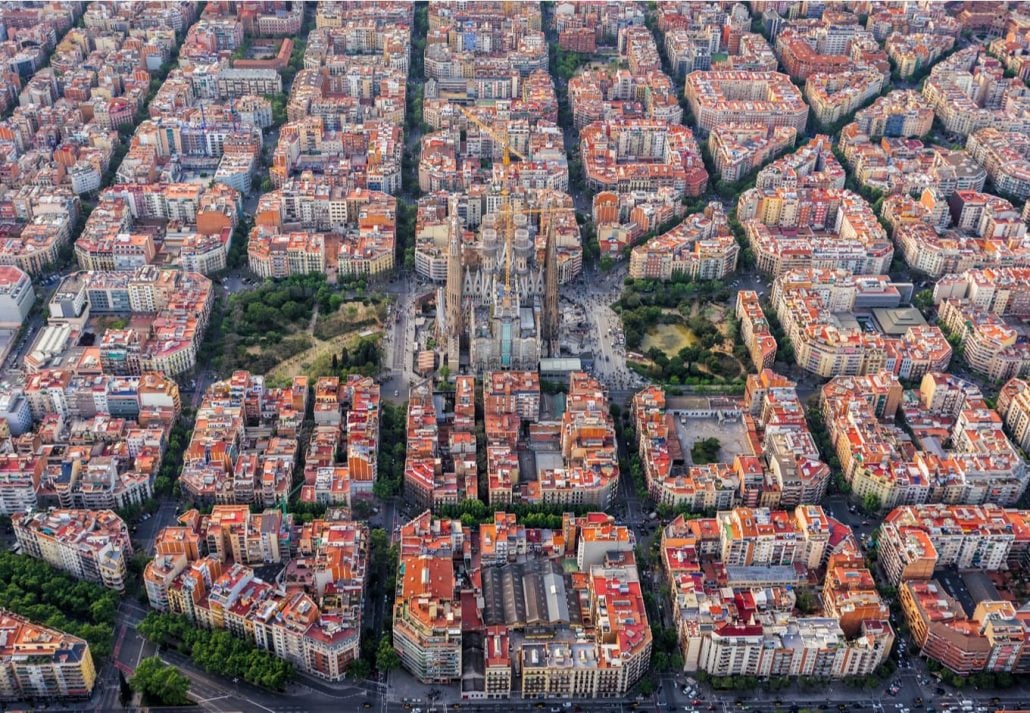 Aerial view of Barcelona's Eixample neighbourhood with the Sagrada Familia in the middle.