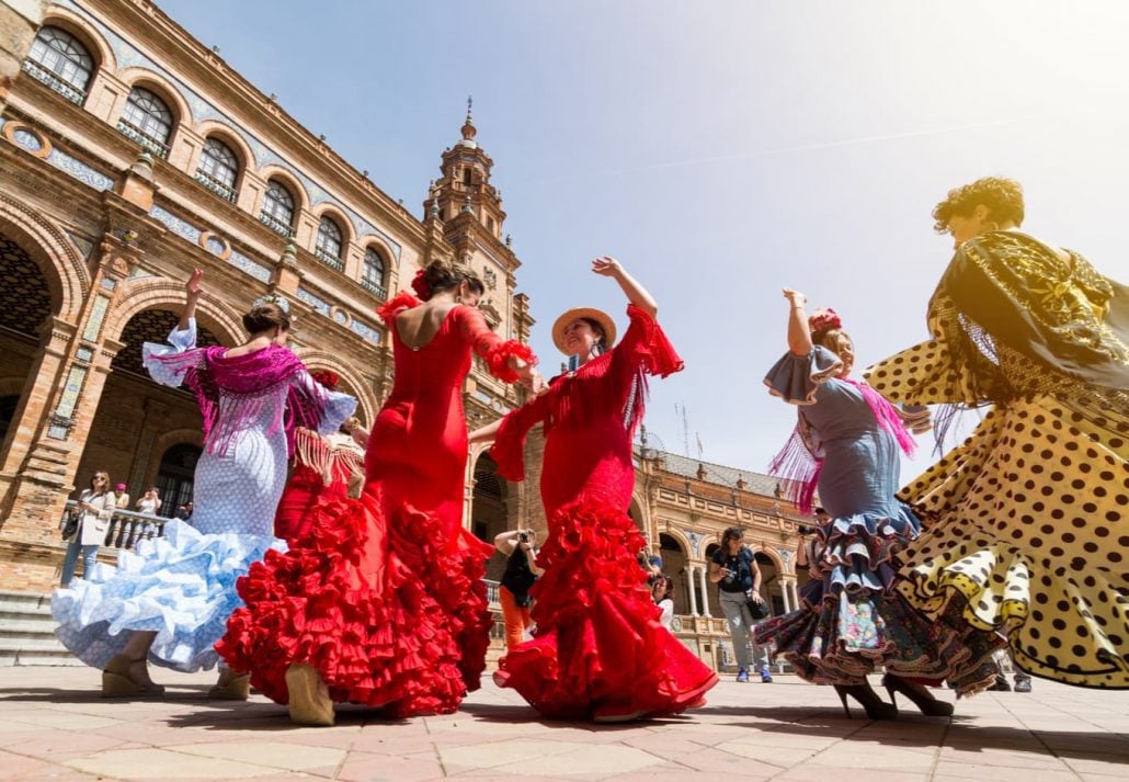 Young women dance flamenco on Plaza de España, Seville.