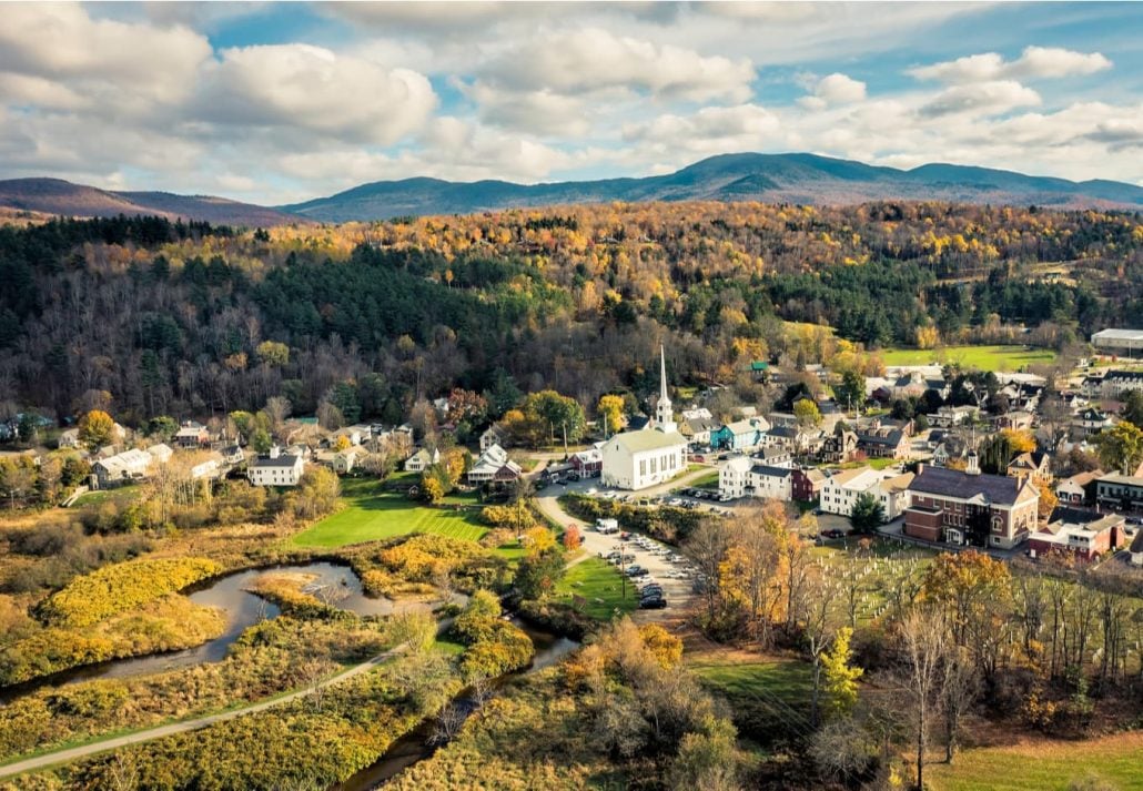 Aerial view of charming small town Stowe in Vermont. Mountains with fall multicolor trees.