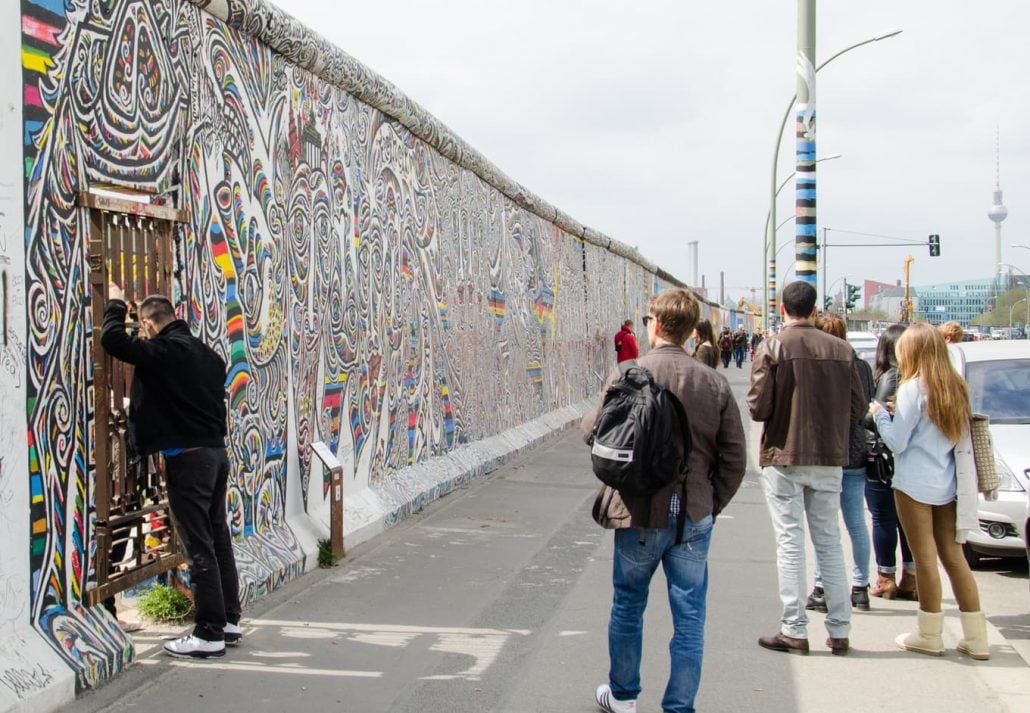 People in front of the East Side Gallery, Berlin, Germany.