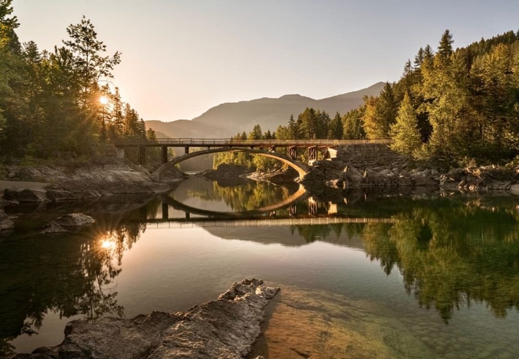 A sunrise across Belton Bridge over Middle Fork Flathead River near West Glacier in Glacier National Park, Montana, USA