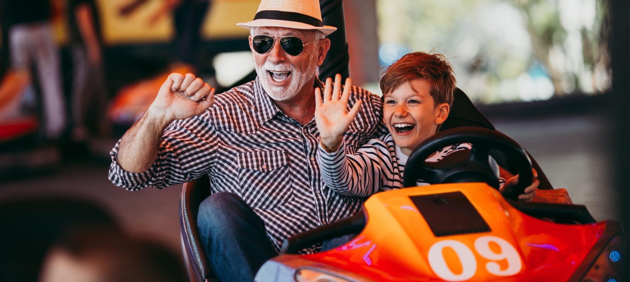 A boy with a grandpa at an amusement park
