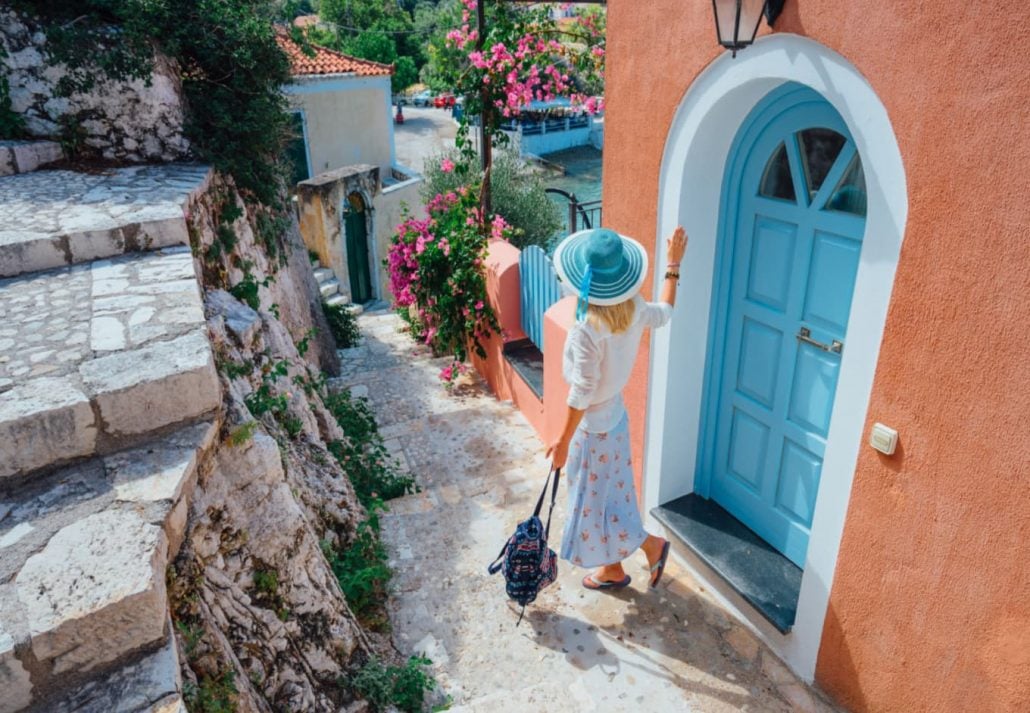 A female tourists walking down the stairs in Greece