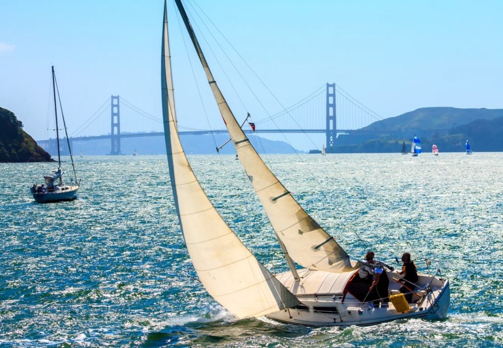 Couple sailboating in the San Francisco Bay Area, in San Francisco, California.