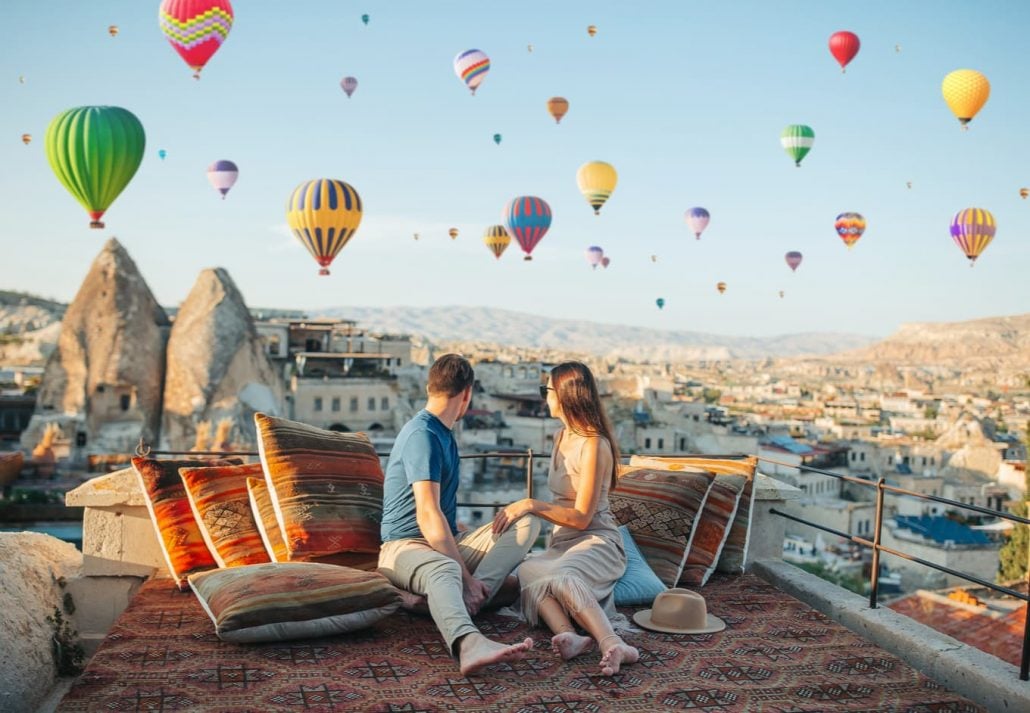 Couple watching the flight of hot air balloons in Cappadocia, Turkey.