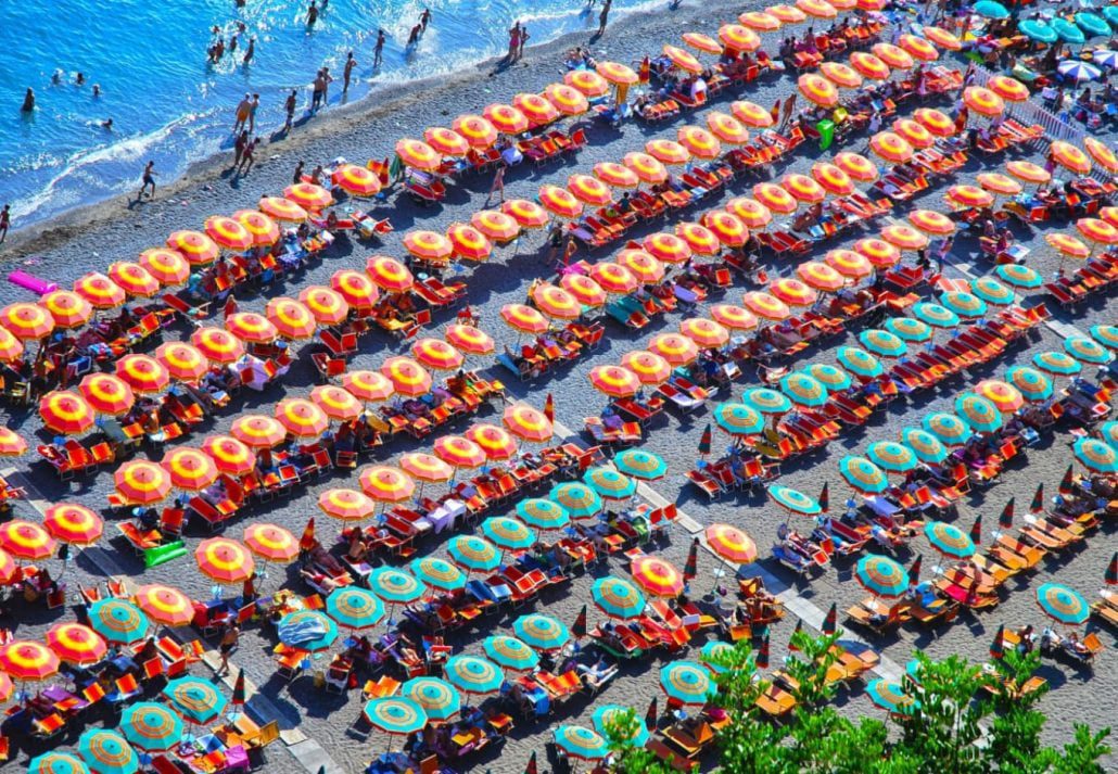 A beach full of colorful umbrellas in Positano