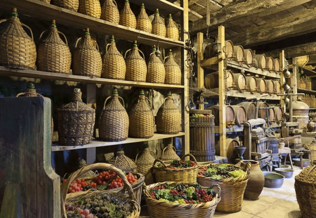 A wine cellar with baskets of grapes