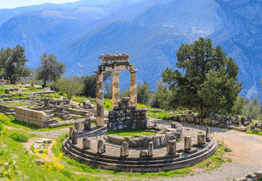 Delphi ruins with trees around it and hills as the backdrop