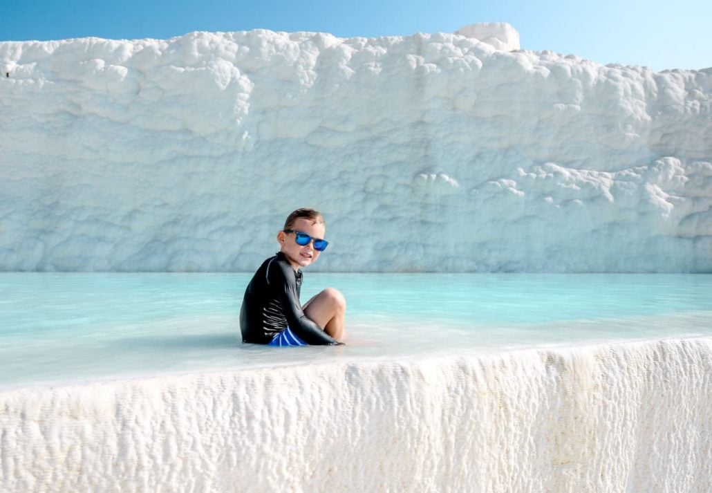 A boy sitting in a thermal pool in Pamukkale