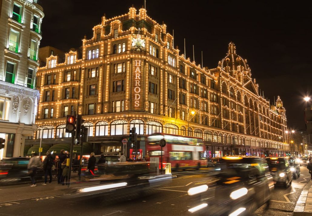 Harrods department store lit up at nightime, in London, England.