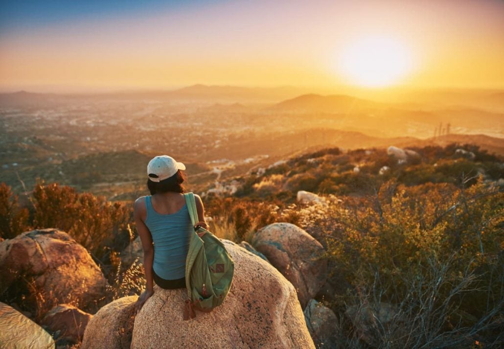 Young woman watching the sunset in San Diego, California.