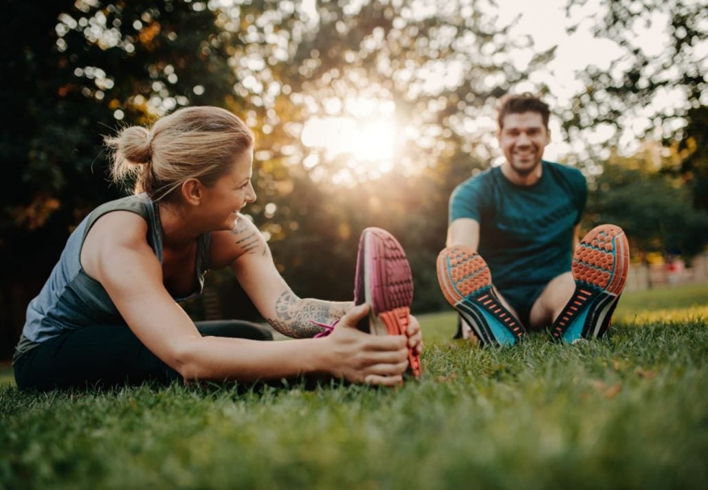 a woman and a man warming up for a workout