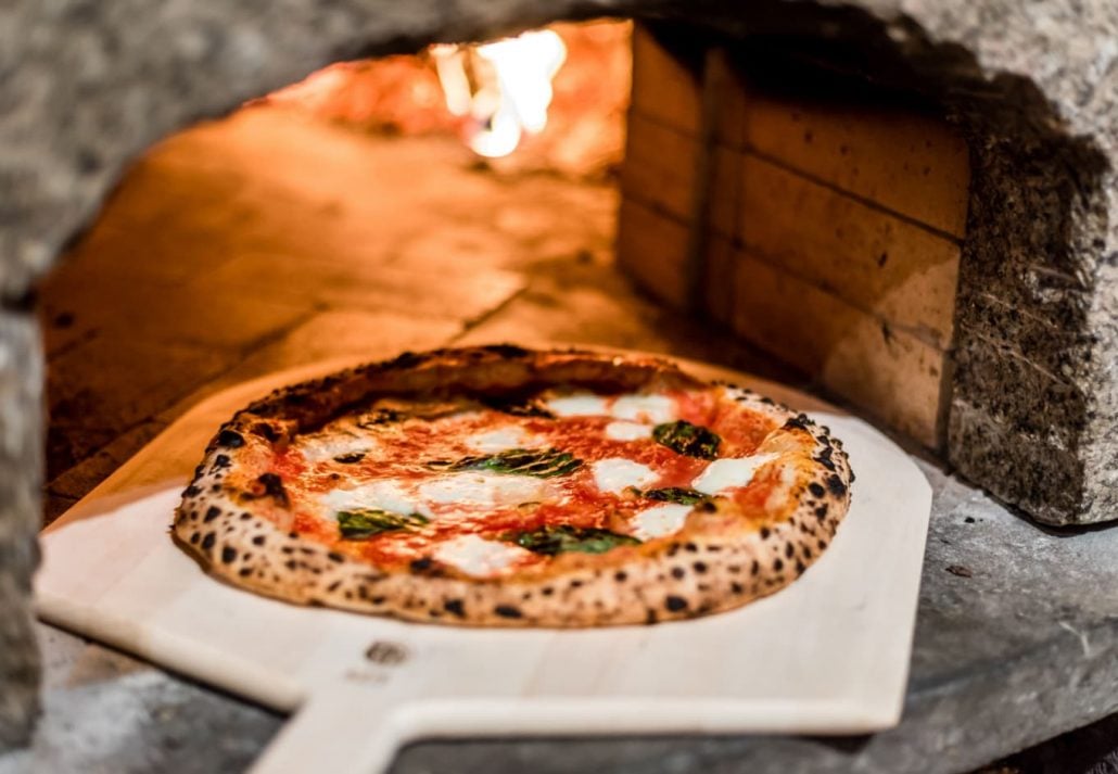 Neapolitan pizza in a brick oven.