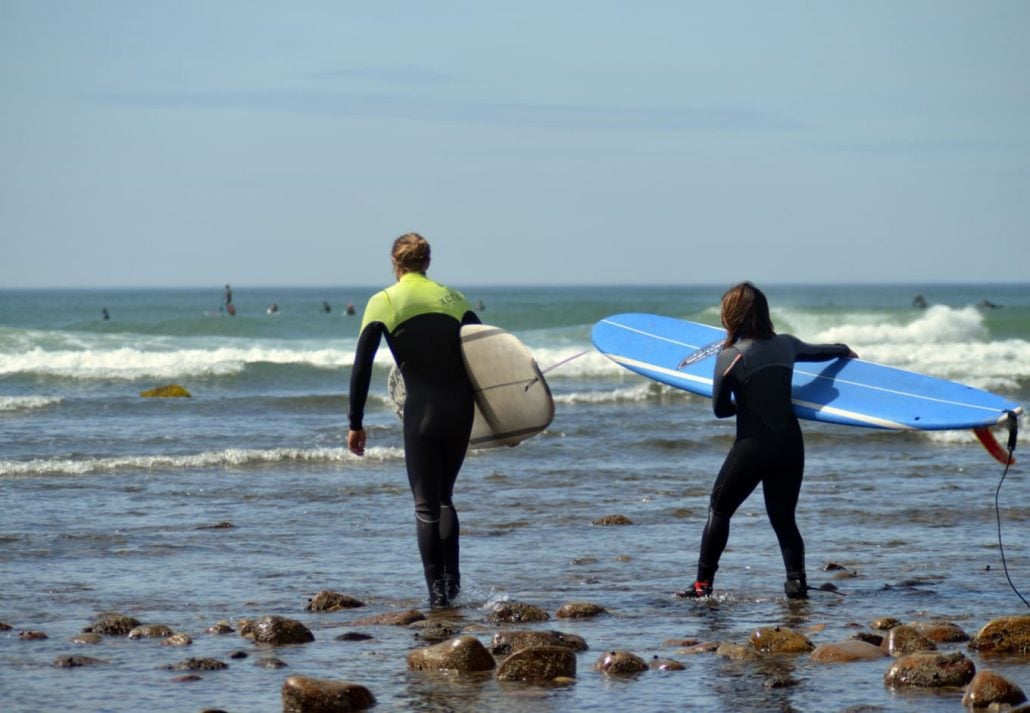 Two people surfing on the Ditch Plains Beach, Montauk, New York.