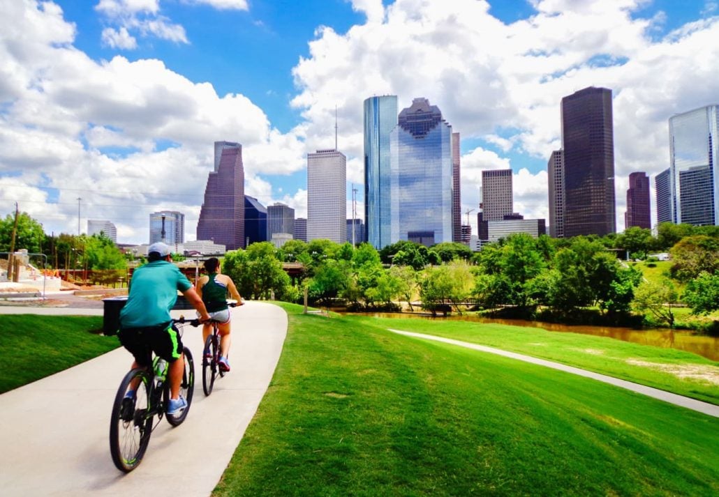 A couple biking in a park in Houston, Texas.