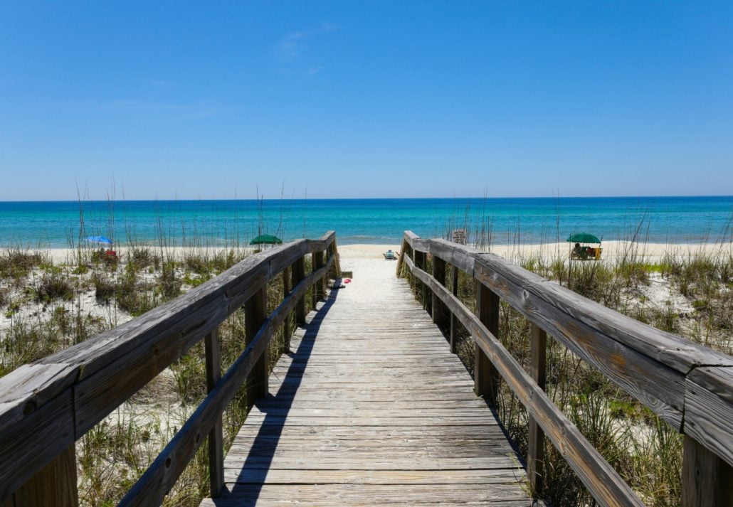 A beautiful view of a wooden path going to Henderson Beach State Park Destin, Florida, USA.