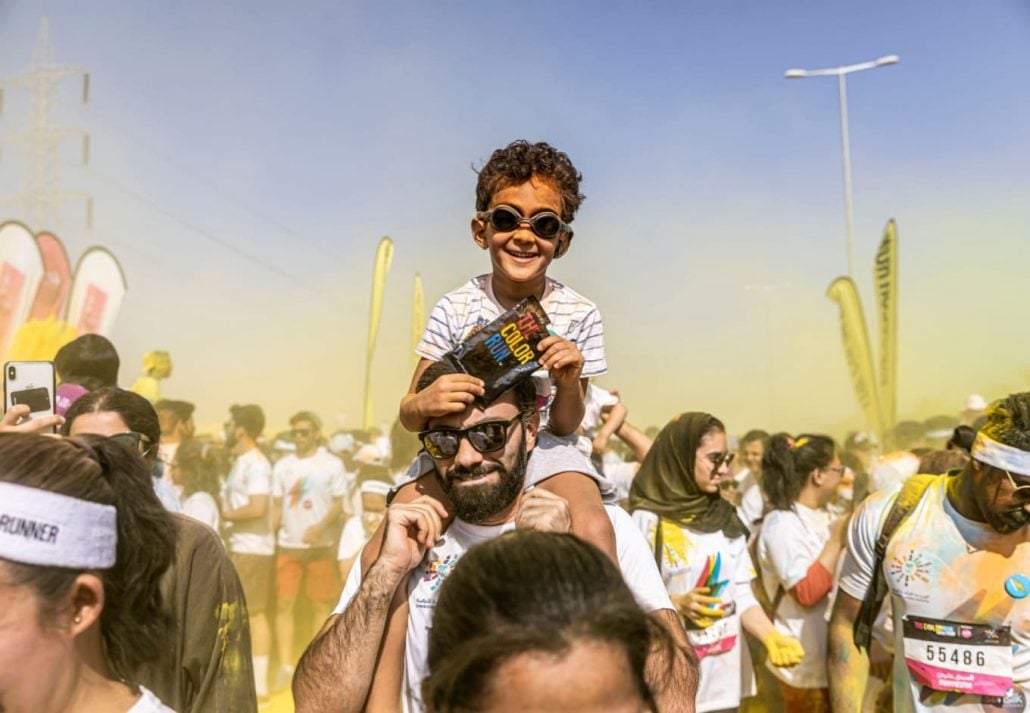 a father and son at a colorful event in Boulevard