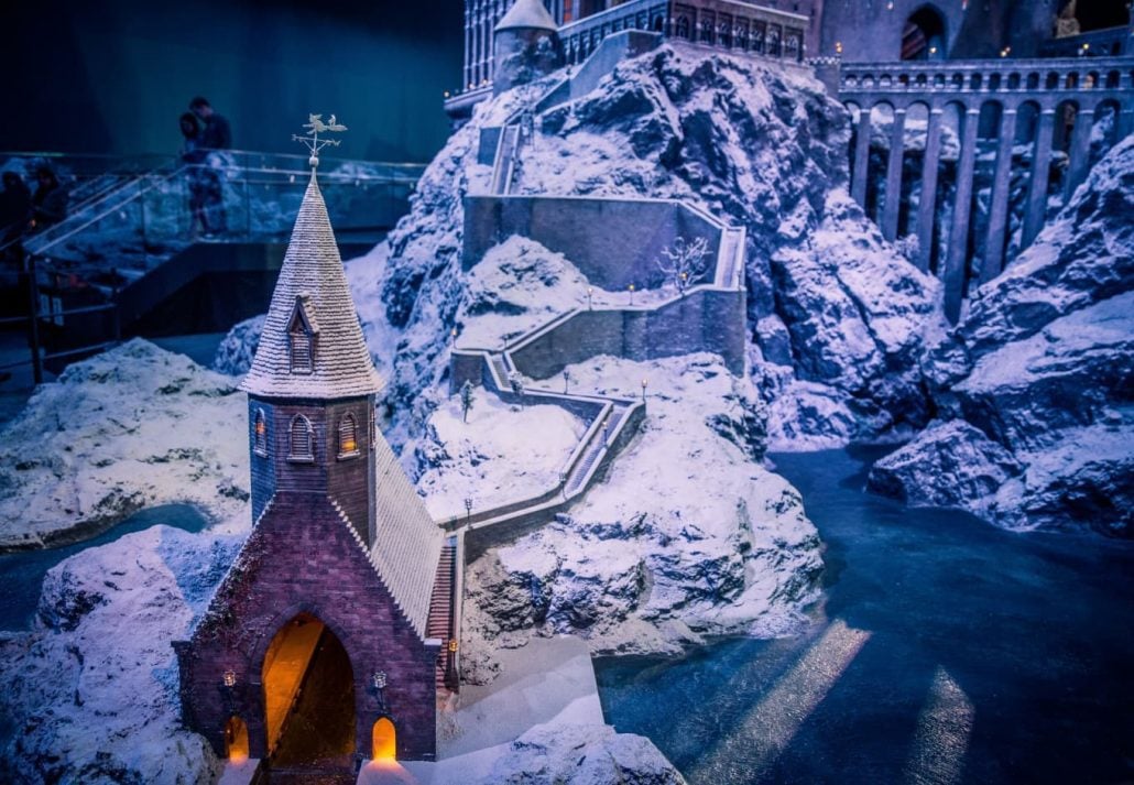 a castle on a snow-covered hill at Hogwarts in the Snow
